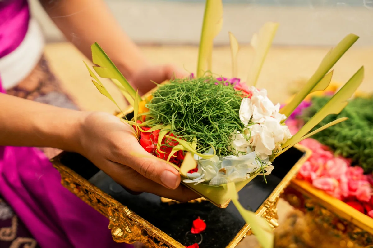 Canang Sari in Woman's Hands inBali Temple Offering Pray.jpg
