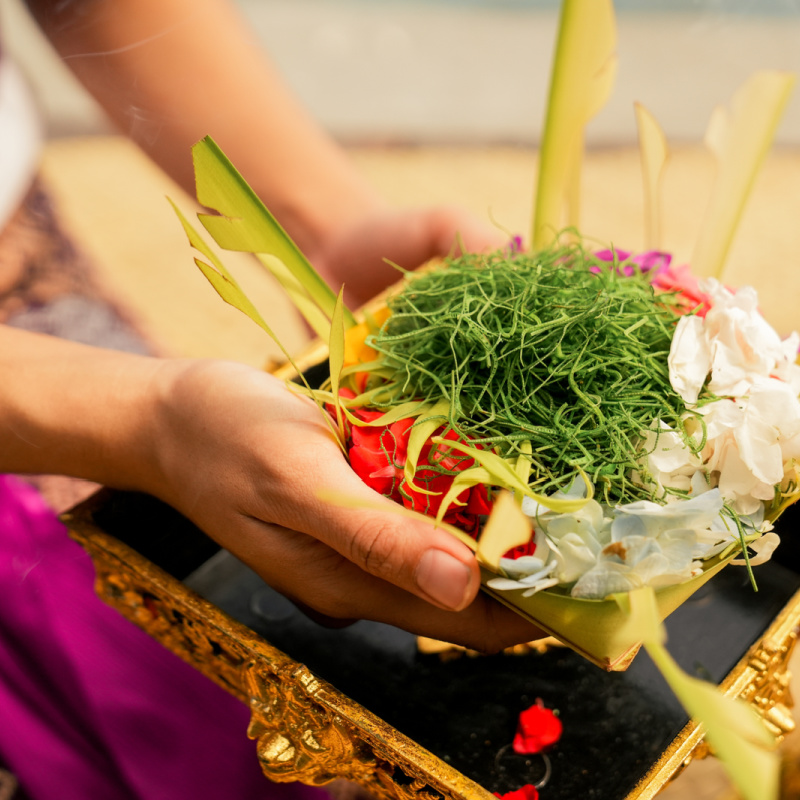 Canang Sari in Woman's Hands inBali Temple Offering Pray
