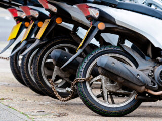 Close Up Of Mopeds Chained Together.jpg