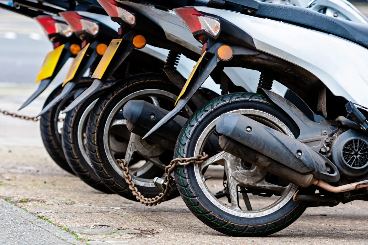 Close Up Of Mopeds Chained Together.jpg
