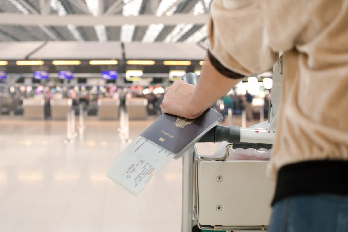 Passport In Hand At Airport.jpg