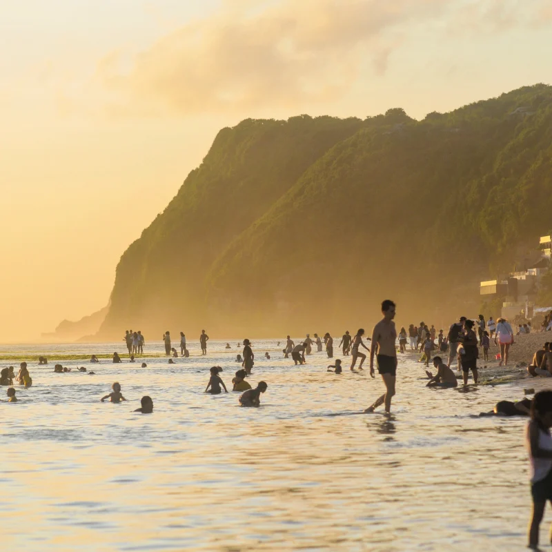Tourists Enjoy Sunset At Uluwatu Beach Bali