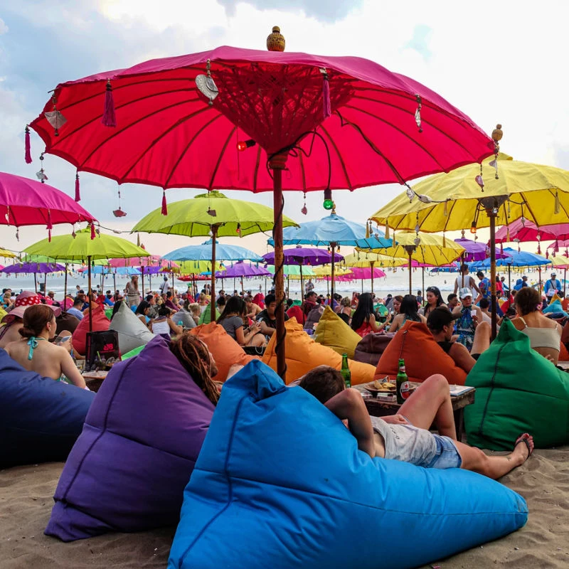 Beach Bean Bags and Umbrellas on Busy Seminyak beach in Bali