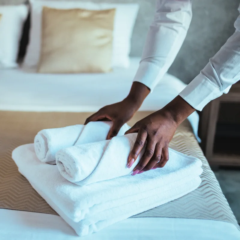 Hotel Worker Makes Bed in Luxury Hotel Room in Bali