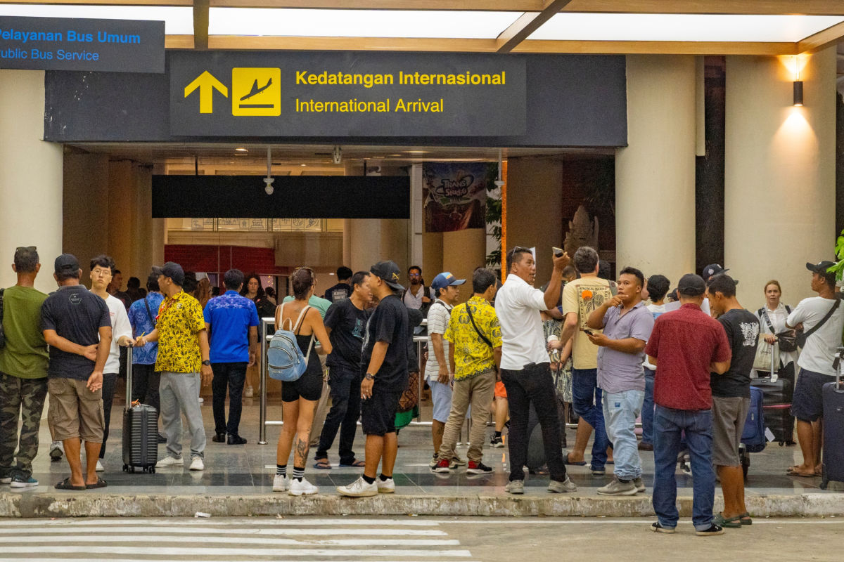 Tourists and Taxi Drivers At Bali Airport International Arrivals.jpg