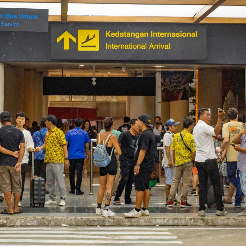 Tourists and Taxi Drivers At Bali Airport International Arrivals
