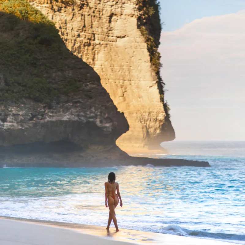 Woman Walks Along Diamond Beach in Nusa Penida