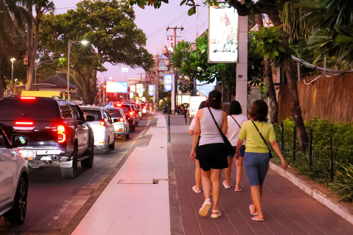 Tourists Walk Along Pavement Sidewalk in Kuta Bali.jpg