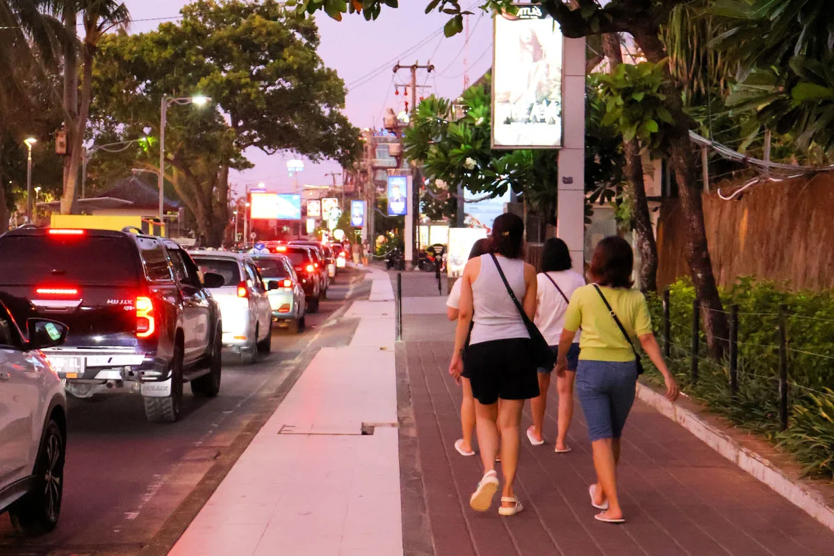 Tourists Walk Along Pavement Sidewalk in Kuta Bali.jpg