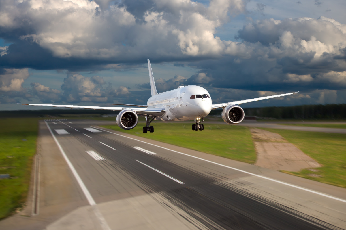 Plane Takes Off From Airport Runway.jpg