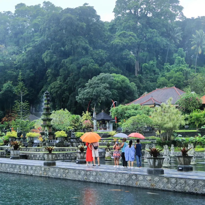 Tourists in the Rain At Tirta Gangga Park and Gardens