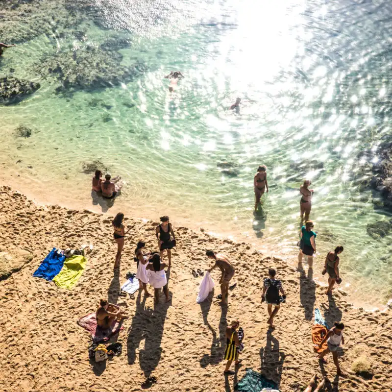 View of Surfers on Bali Uluwatu Beach