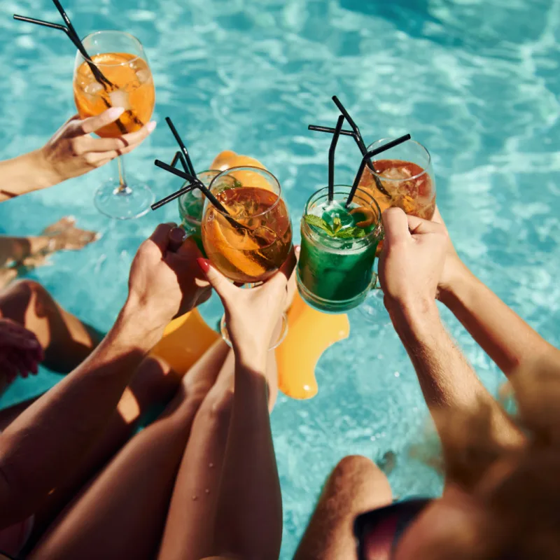 Friends Drink Cocktails In Bali Pool