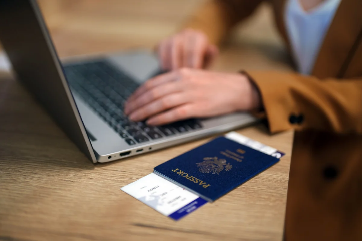 Laptop and Passport on Table