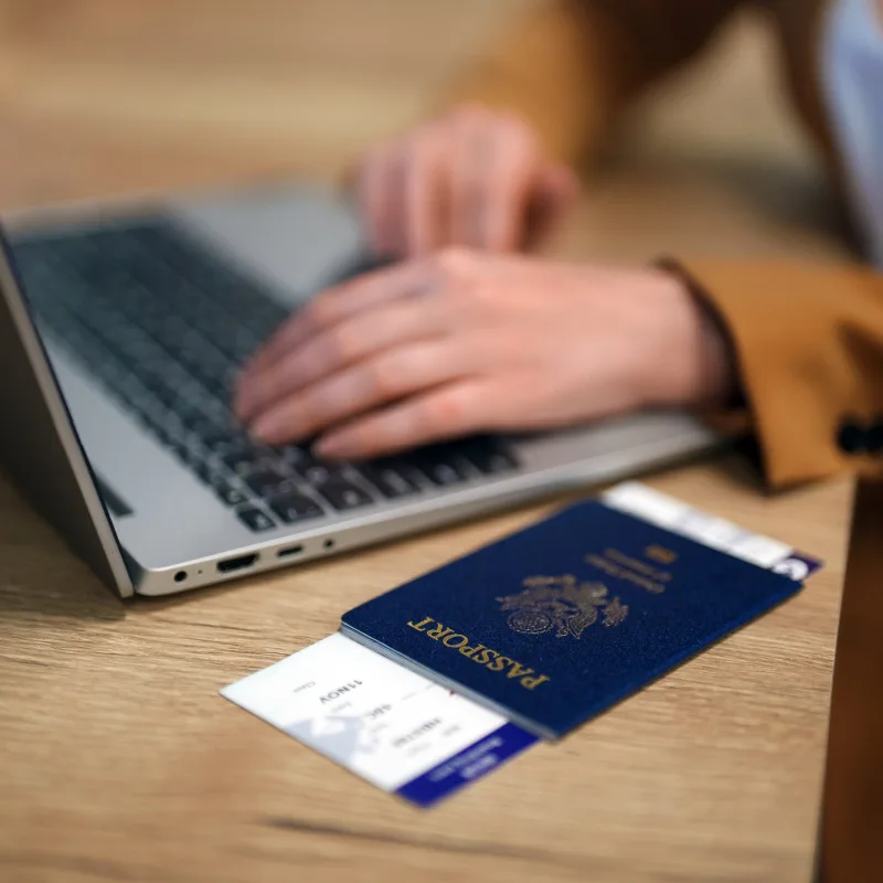 Laptop and Passport on Table