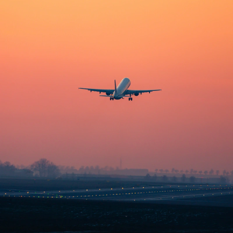 Plane Takes Off at Sunset