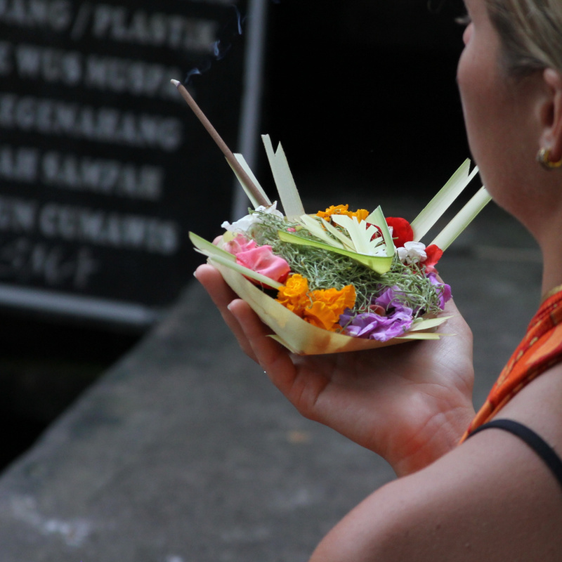 Tourist with Canang Sari Before Melukat Ceremony